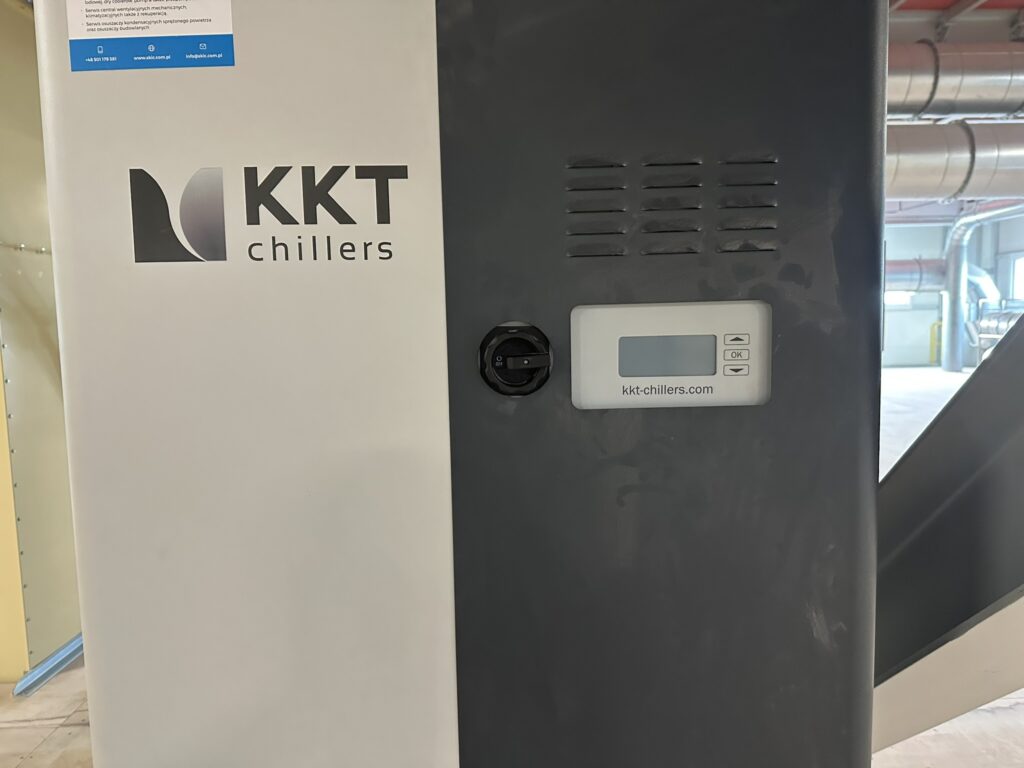 Front obudowy chłodziarki KKT chillers z panelem sterowania i wyłącznikiem głównym w hali produkcyjnej